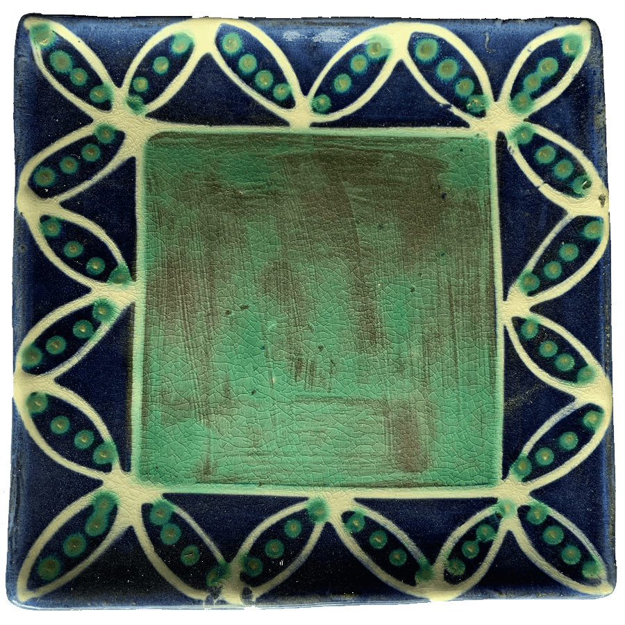 Pottery design with blue with white pods and green seeds.