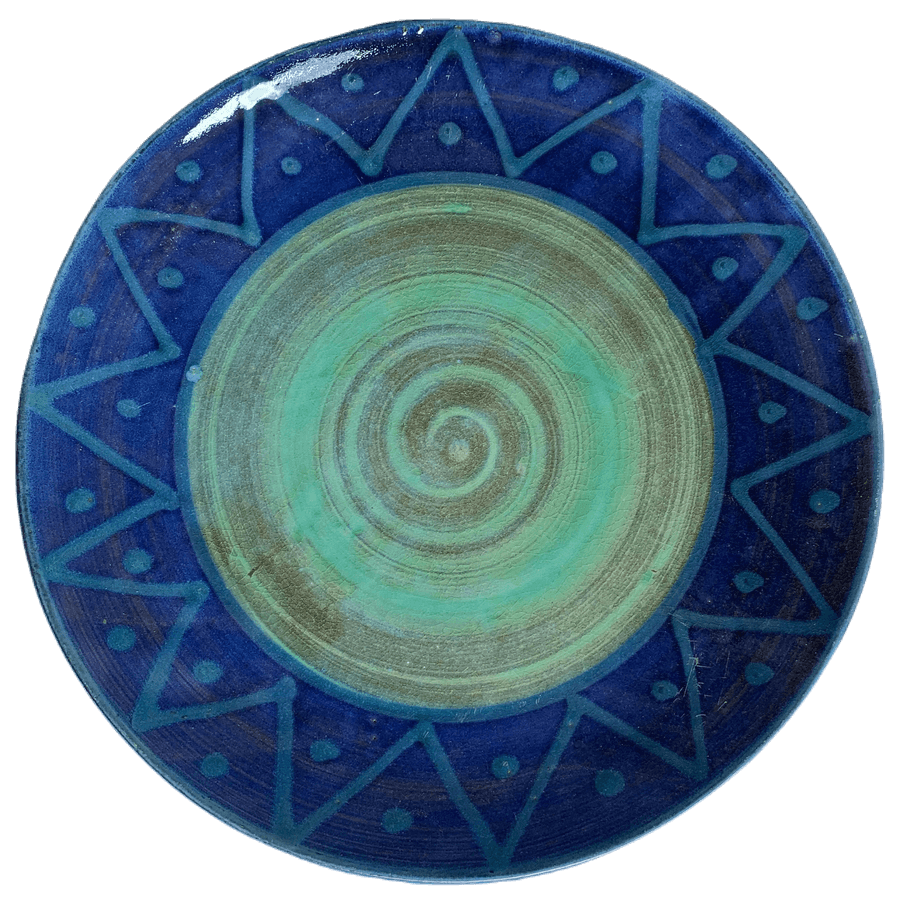 Round pottery design with green centre, turquoise sunburst on blue background.